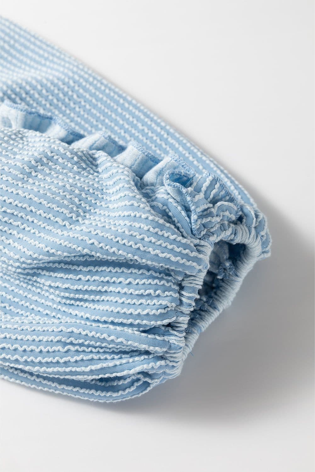 image-Mist Blue Puff Sleeve Corded Blouse with Frilly Detail (56 characters)