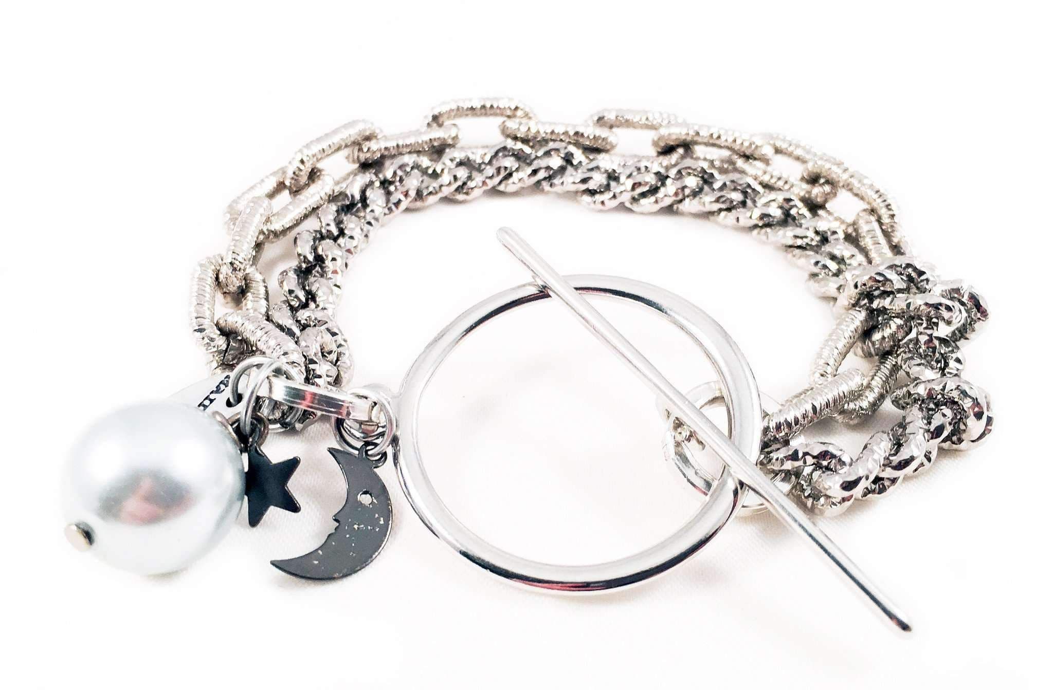 image-Silver bracelet with light blue pearl and black moon. Perfect for