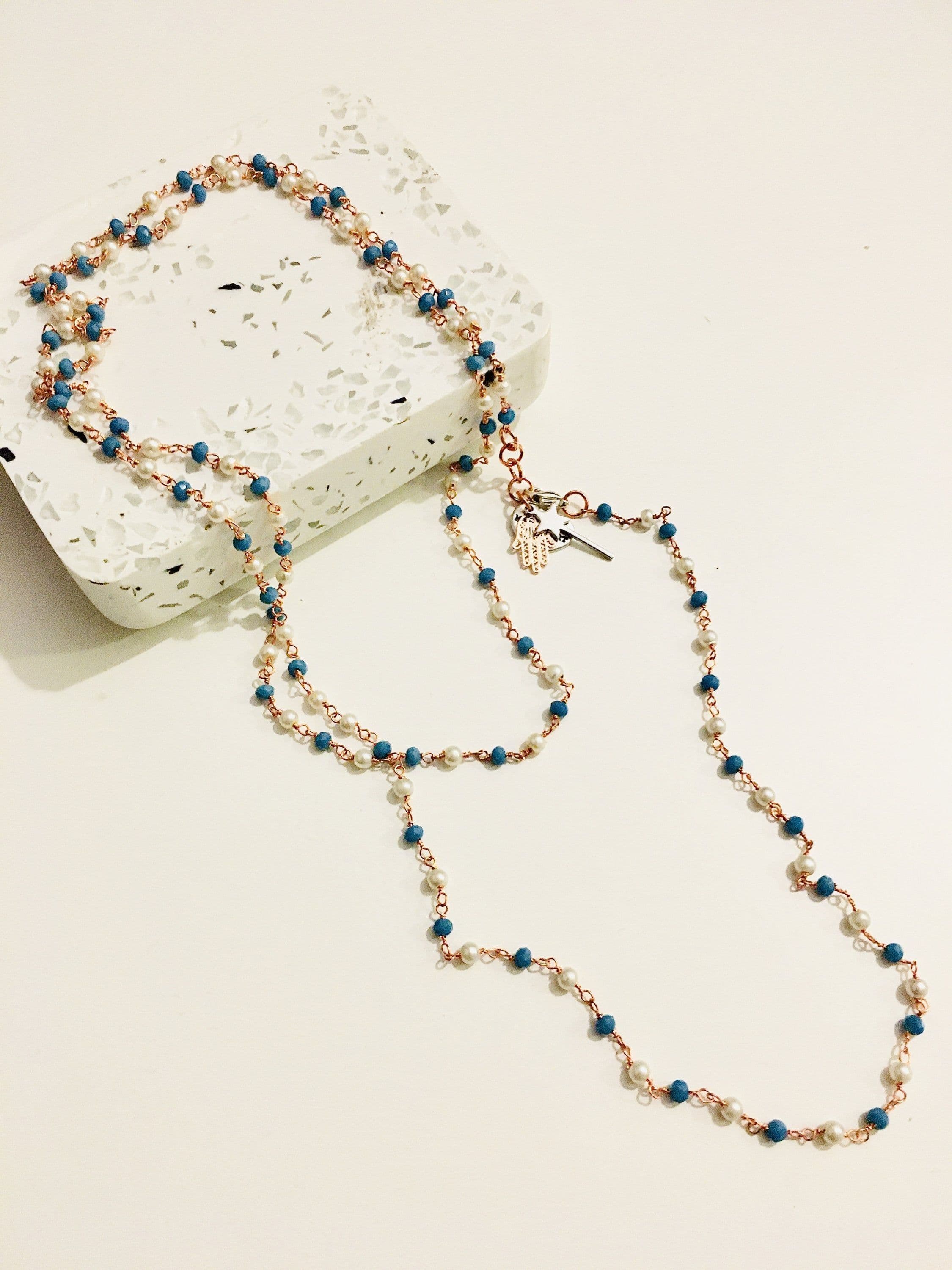 image-Rosary pearls and blu stones long necklace with magic wand and hamsa