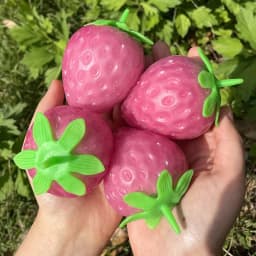 image-Simulated Colorful Strawberry Squeezing Music To Vent
