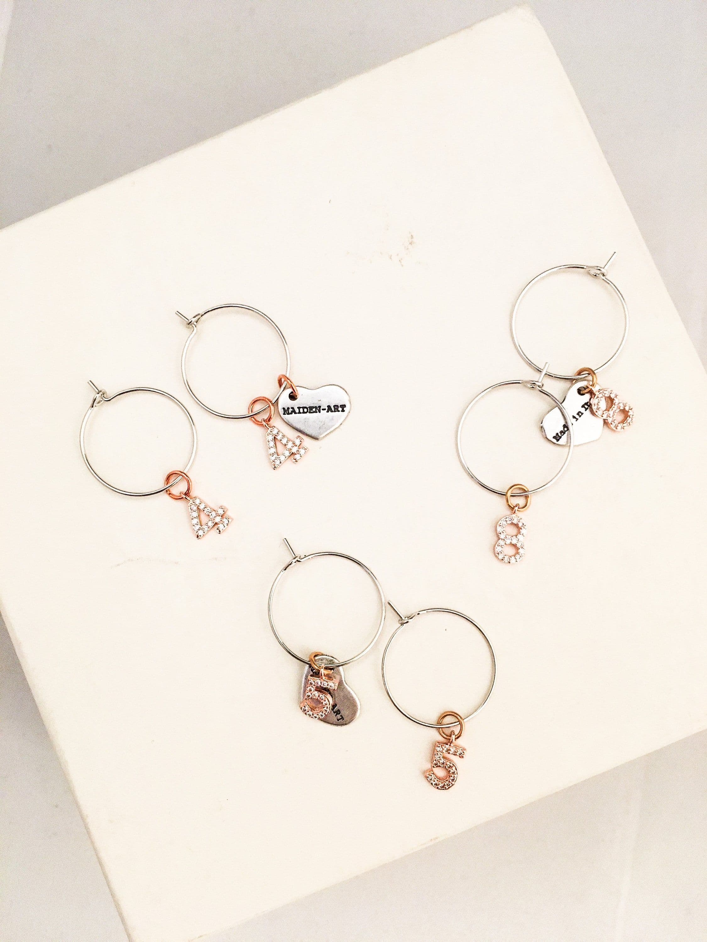 image-Number hoop earrings in silver, rose gold and rhinestones.