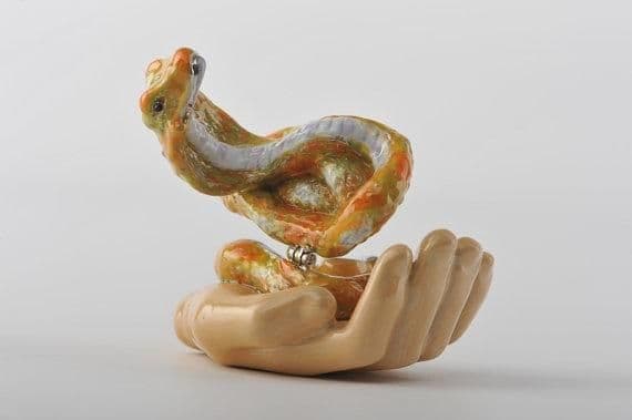 image-Zodiac Snake Laying on Hand